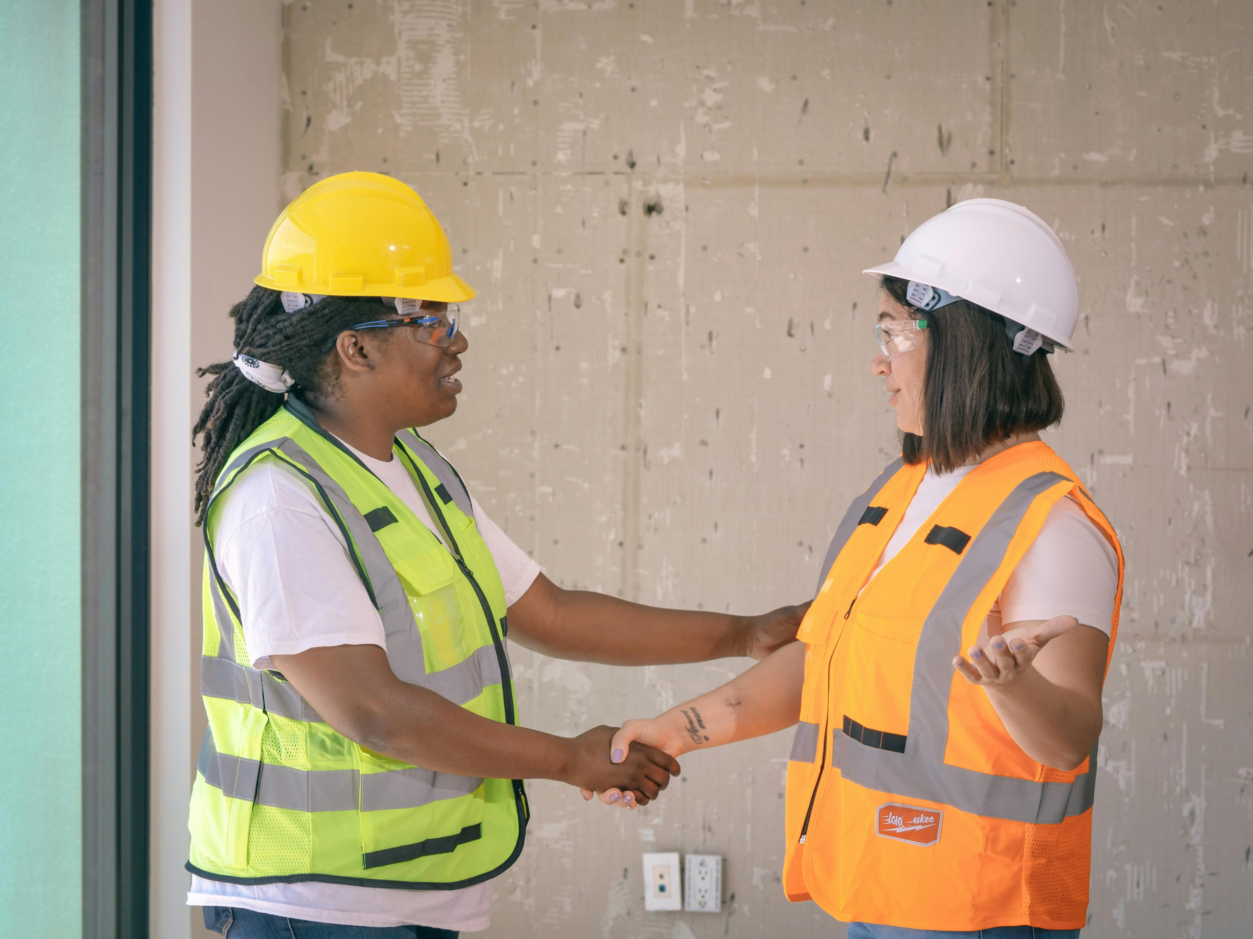 Construction workers shaking hands